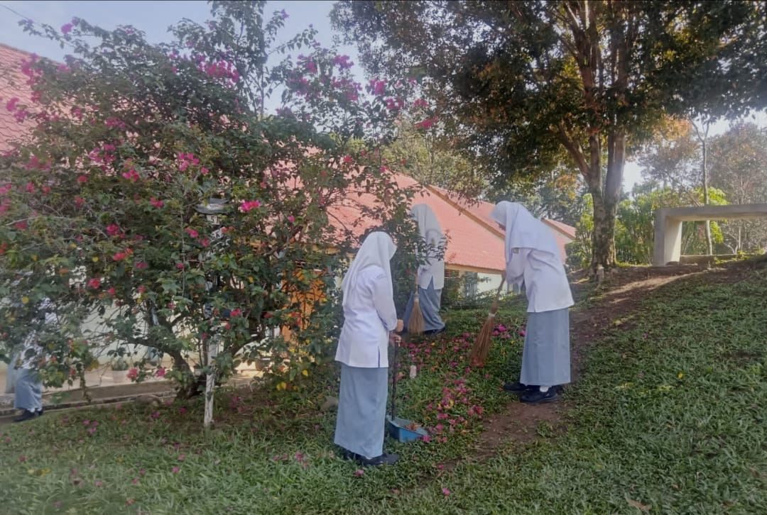 Siswa siswi SMKN 2 Batangtoru sedang merawat pepohonan yang ada di sekitar lingkungan sekolah.(DETEKSI.co/Zatam)